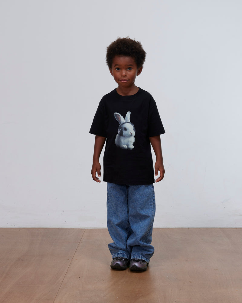 Kid model wearing the black Patta Kids Bunny T-Shirt featuring a bunny graphic.