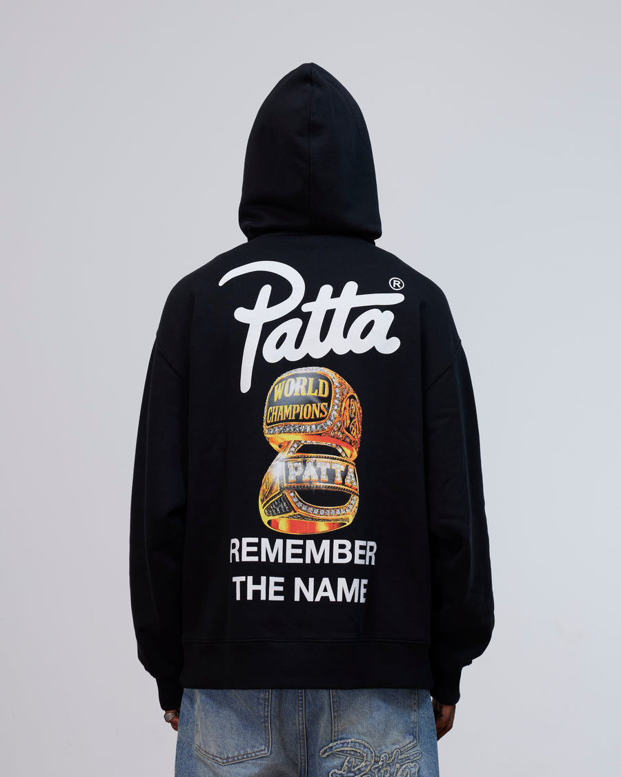 Back view of the Patta Kids Championship Hooded Sweater in black with rings graphic and logo print.